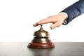 Woman ringing hotel service bell at grey table Royalty Free Stock Photo