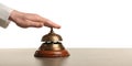 Woman ringing hotel service bell at stone table Royalty Free Stock Photo