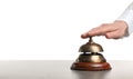 Woman ringing hotel service bell at stone table Royalty Free Stock Photo