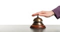 Woman ringing hotel service bell at stone table Royalty Free Stock Photo