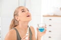 Woman rinsing mouth with mouthwash in bathroom. h care Royalty Free Stock Photo