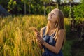 A woman and a ripe harvest of rice. Rice porridge, rice flakes,