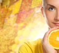 Woman with ripe orange