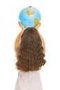 Woman rising earth globe . rear view Royalty Free Stock Photo