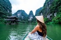 A woman on a river boat in Ninh Binh. Mountains of northern Vietnam. Royalty Free Stock Photo
