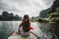 A woman on a river boat in Ninh Binh. Mountains of northern Vietnam. Royalty Free Stock Photo