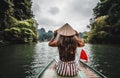 A woman on a river boat in Ninh Binh. Mountains of northern Vietnam. Royalty Free Stock Photo