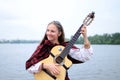 Woman on the river playing celtic medieval music,Ukraine