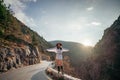 Woman road mountain. A woman in a white sweater, black boots and a hat walks along a winding alpine path between the Royalty Free Stock Photo