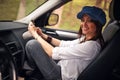 Woman on a road trip. Smiling girl listening to music on your sm Royalty Free Stock Photo