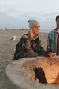 Woman roasting a marshmallow over a bonfire