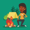 Woman roasting marshmallow over campfire.