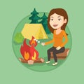 Woman roasting marshmallow over campfire.