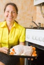 Woman roasting stuffed chicken