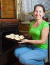 Woman roasting stuffed vegetable marrow Royalty Free Stock Photo