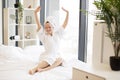 Woman in robe and towel relaxing on bed at home Royalty Free Stock Photo