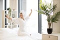 Woman in robe and towel relaxing on bed at home Royalty Free Stock Photo