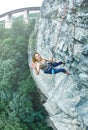 Woman rock climber climbed on the cliff