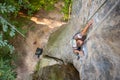 Woman rock climber is climbing on a rocky wall Royalty Free Stock Photo