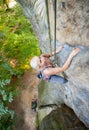 Woman rock climber is climbing on a rocky wall Royalty Free Stock Photo