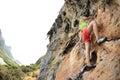 Woman rock climber climbing at seaside mountain cliff rock Royalty Free Stock Photo