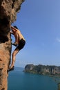 Woman rock climber climbing at seaside mountain rock Royalty Free Stock Photo