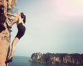 woman rock climber climbing at seaside mountain rock Royalty Free Stock Photo