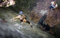 Woman rock climbing with carbines and rope