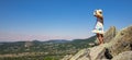 Woman on a rock enjoying panoramic view of france vulcano landscape