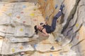 Woman on rock wall in sport centre