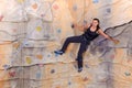 Woman on rock wall in sport centre