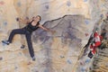 Woman on rock wall in sport centre