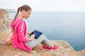Woman on a rocky beach with a tablet in the spring Royalty Free Stock Photo