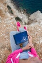 Woman on a rocky beach with a tablet in the spring Royalty Free Stock Photo