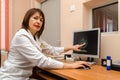 Woman roentgenographer in office of polyclinic indicates changes Royalty Free Stock Photo