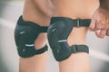 Woman rollerskater putting on knee protector pads Royalty Free Stock Photo