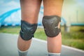 Woman rollerskater wearing knee protector pads