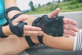 Woman rollerskater wearing wrist guards protector pads