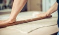 Woman rolling dough on wooden table with wooden rolling pin Royalty Free Stock Photo