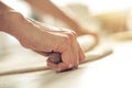 Woman rolling dough on wooden table with wooden rolling pin Royalty Free Stock Photo
