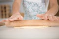 woman rolling pizza dough using rolling pin Royalty Free Stock Photo