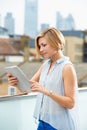 Woman On Roof Terrace Using Digital Tablet Royalty Free Stock Photo