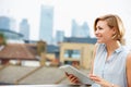 Woman On Roof Terrace Using Digital Tablet Royalty Free Stock Photo