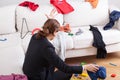 Woman in room of messy clothes