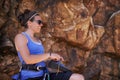 Woman, rope and rock climbing with shoes, adventure and laugh outdoor in the mountain. Training, exercise and workout Royalty Free Stock Photo