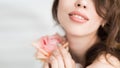 The woman with a rose. A photo close up view of a female lips and a flower. Selective focus