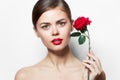 Woman with rose Red lips bared shoulders charm bright makeup Royalty Free Stock Photo