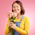 Woman, roses and gift with smile in studio portrait for celebration, birthday or party by pink background. Japanese