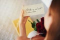 Woman, roses and letter with gift in bedroom on birthday, celebration and valentines day event in home. Girl, reading