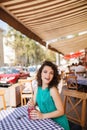 Woman in round sunglasses with cocktail at cafe terrace having fun Royalty Free Stock Photo